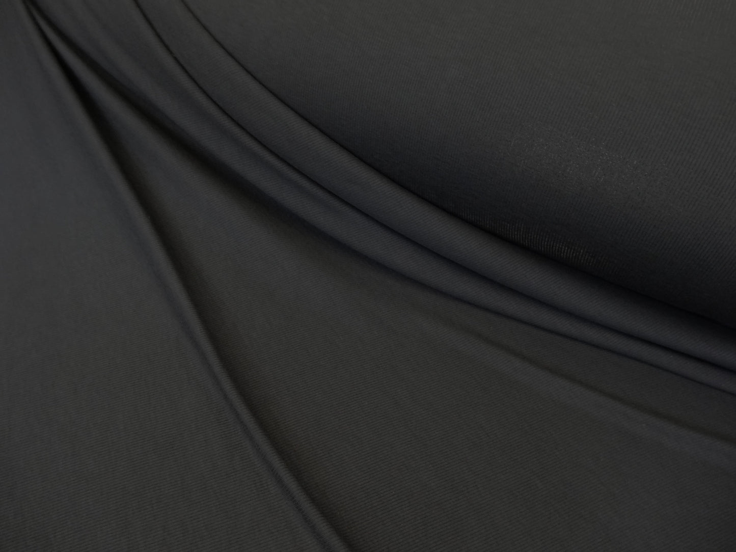 Black knitted fabric with a fine rib.