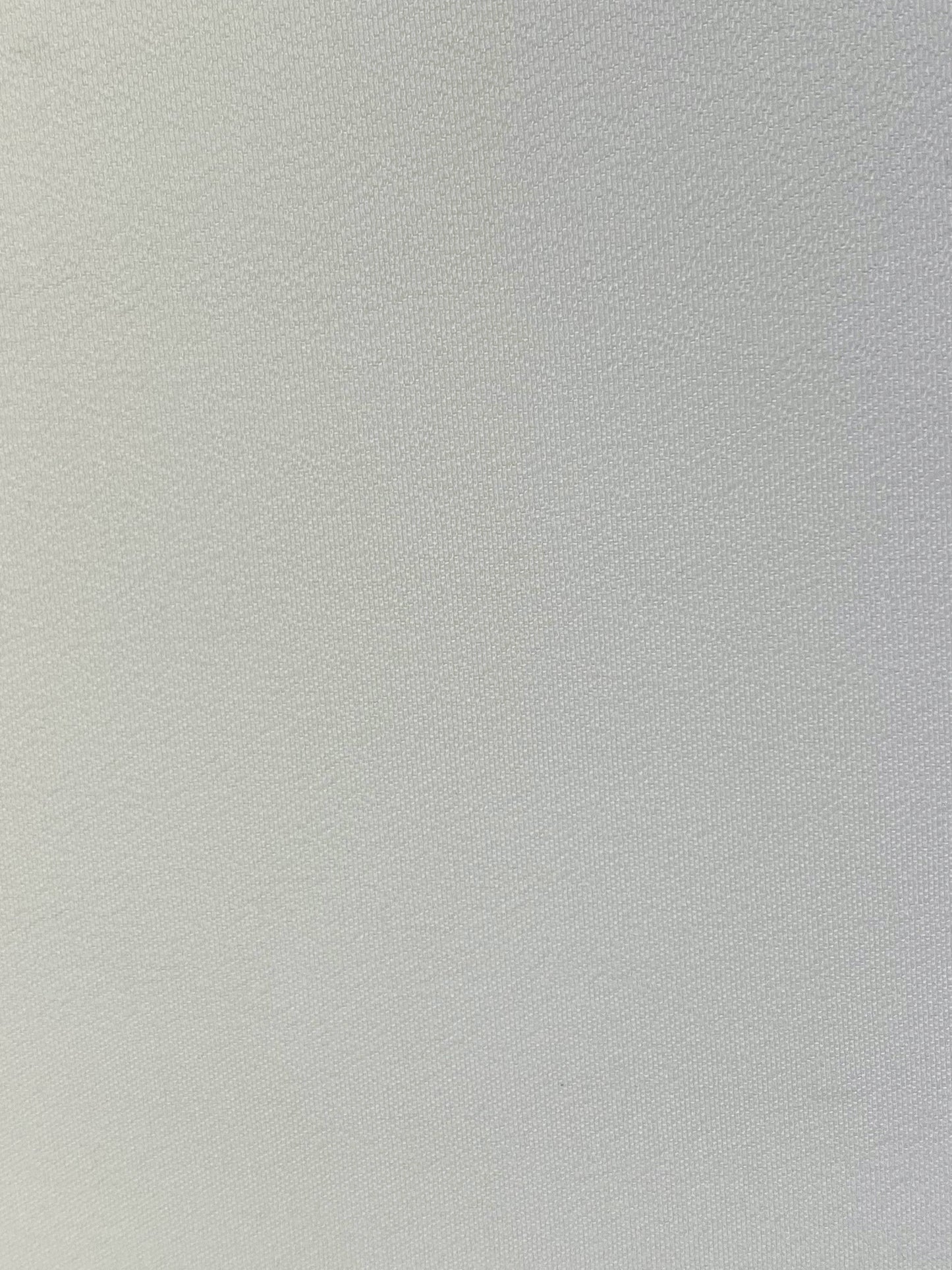 Close up photo of white polyester chiffon fabric laid flat