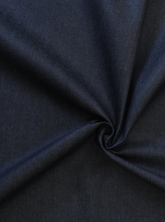 9oz denim fabric in a dark navy with a twist in the fabric showing how the light effects the colour of the fabric