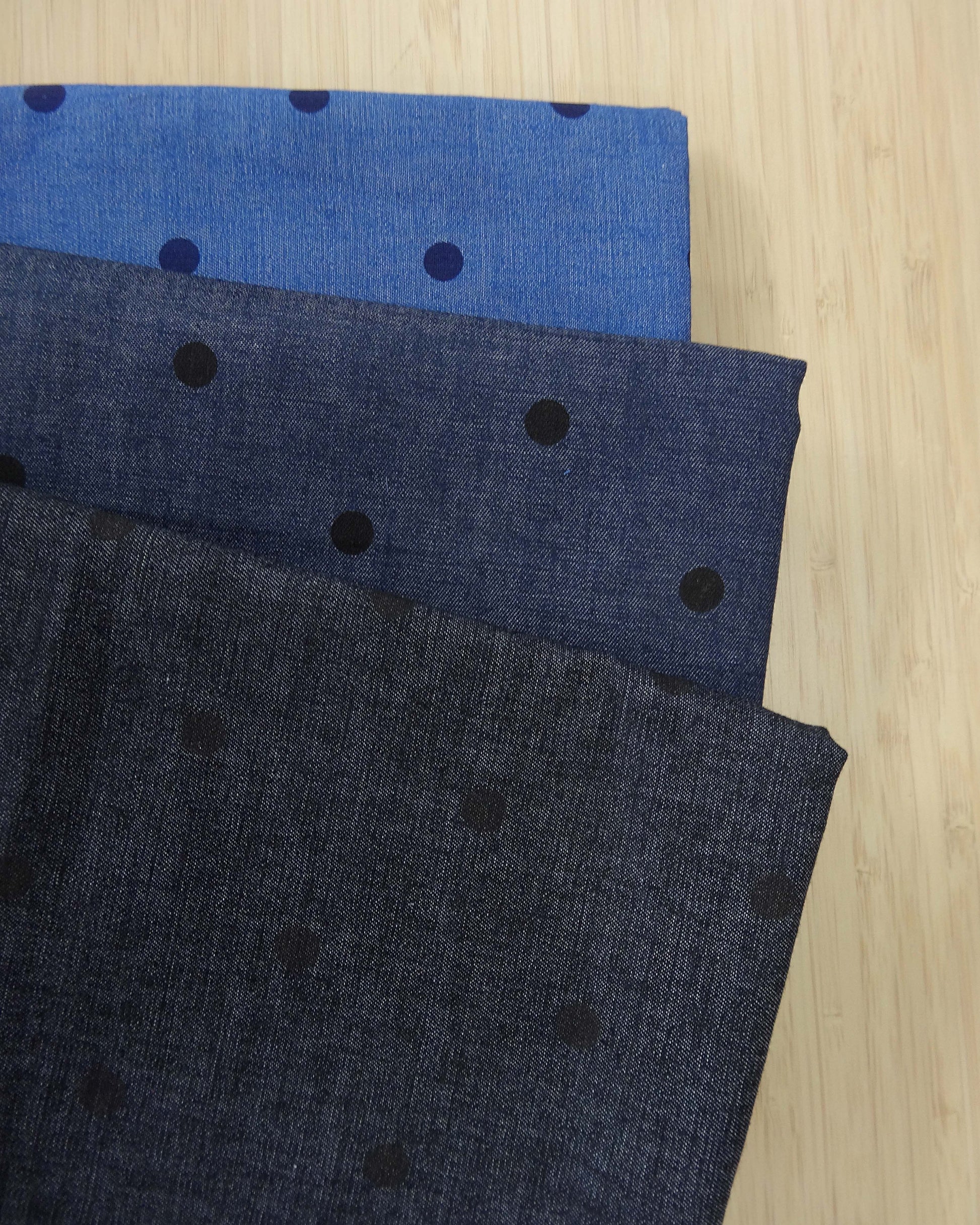 Three shades of denim fabric with polka dot spot print