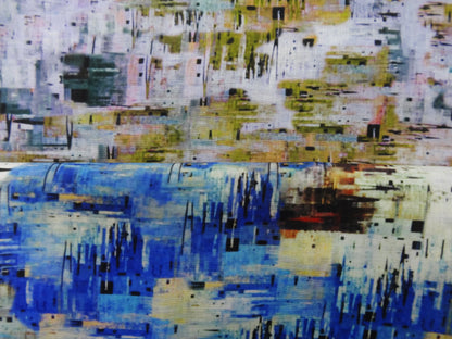 Photo of abstract colours printed on linen cotton blended fabric remnants stacked in yellow/greens and blues. photographed from above.