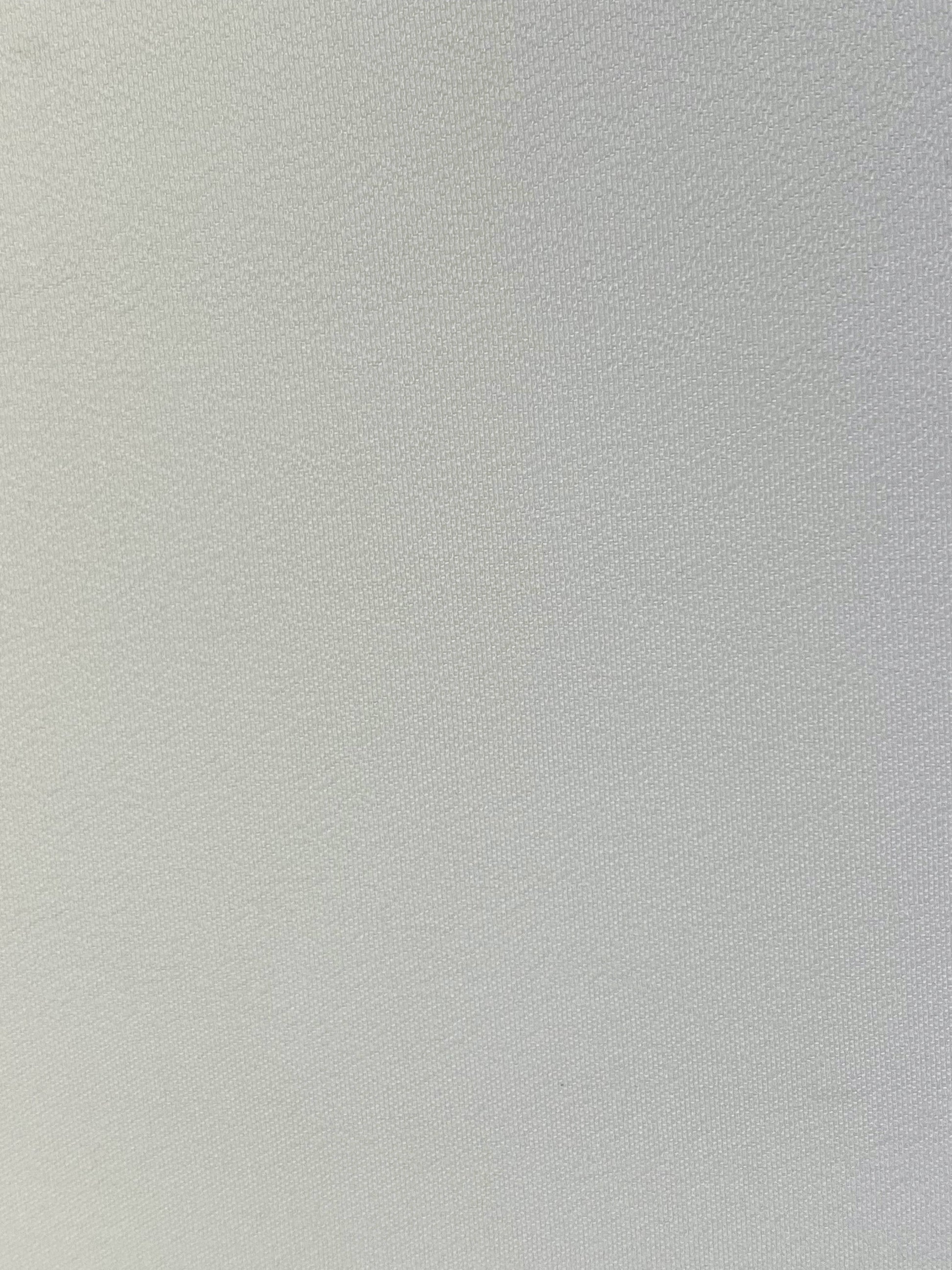 Close up photo of white polyester chiffon fabric laid flat