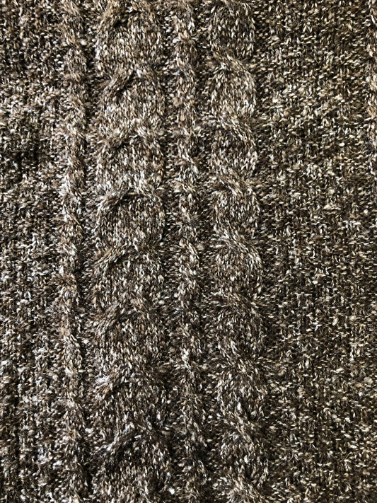 A close up of the brown cable knit wool blend fabric
