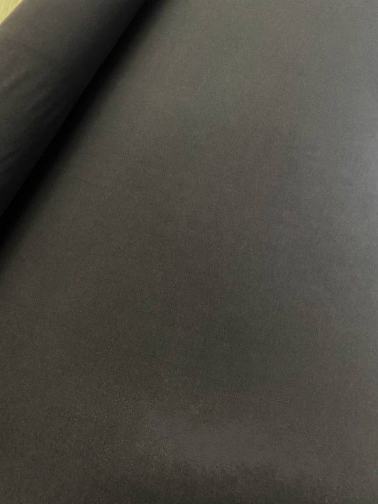 An interlocked knitted jersey fabric in black laid flat